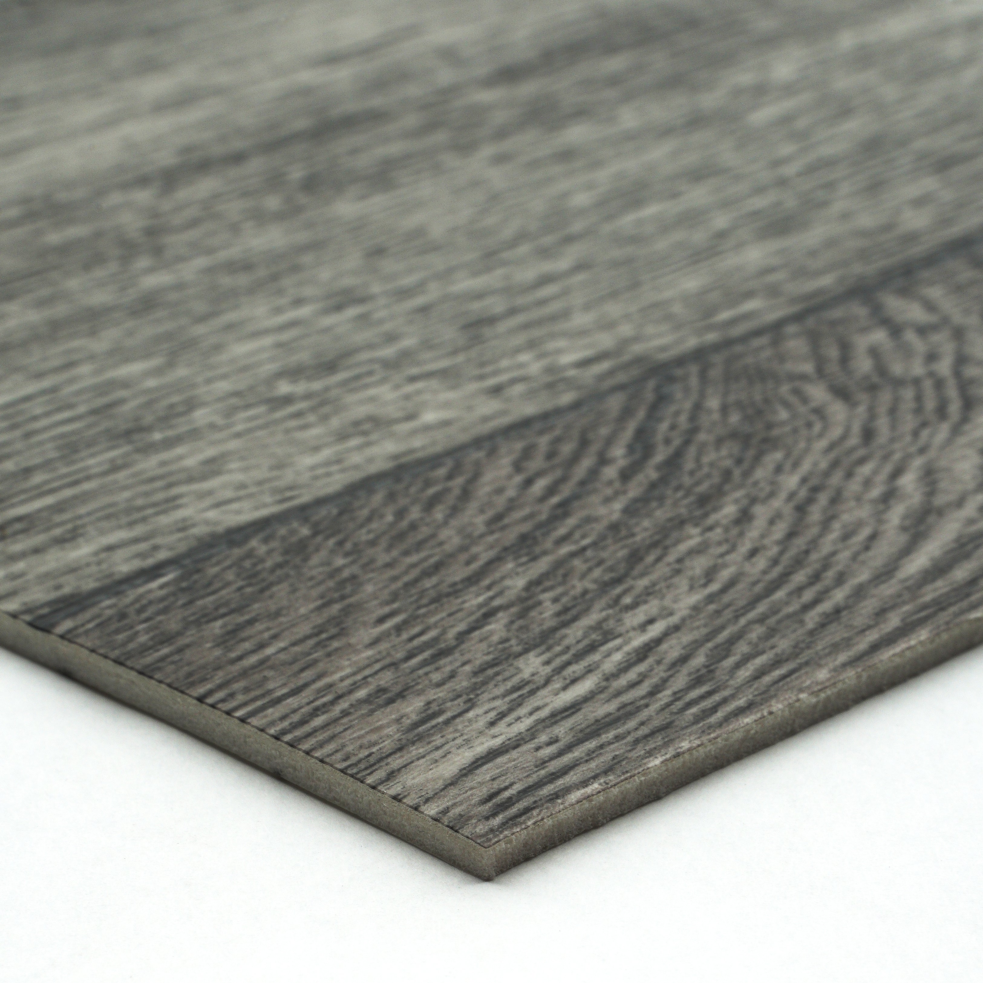 Gray laminate flooring plank with wood grain texture and sleek edge design for modern interiors.